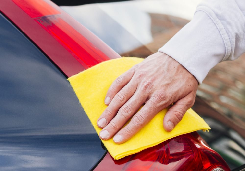 close-up-person-cleaning-car-exterior edex
